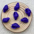 Detail of dark blue conch ceramic beads with gold linear patterns on a wooden tray - Royal Blue