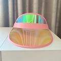Pink trimmed PVC sun visor with rainbow holographic finish on a white display stand - Light Pink