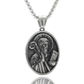 Macro detail of silver Saint Benedict medal pendant on a box chain with embossed texture - St. Benedict