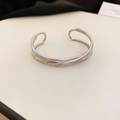 Close-up of polished silver wavy bangle with triple-strand overlapping design for women - Triple-Line Intertwined Style (4#) / Silver
