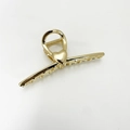 Elegant gold metal hair claw clip featuring a unique twisted design with heart detail - No.7 Gold Twisted Heart