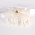 Macro detail of square acetate hair claw clip featuring creamy white pearl texture finish - Pearlescent White