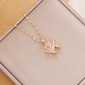 Detail shot of a gold fish pendant with zircon inlay on a beige jewelry box - 3# White Goldfish (Small) / Gold/White