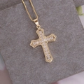 Close-up of 18K gold plated cross pendant with micro-pave cubic zirconia on grey stone - Round Transparent Zircon Cross (9#)