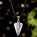Macro detail of hexagonal white crystal pendant with silver clasp and black cord - White Crystal
