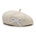 Detailed close-up of beige knit beret featuring a delicate white bow embroidery - Adjustable / Beige