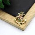Macro shot of 18K gold plated anchor and snake pendant with colorful zircon stones - Anchor Snake Simple Style