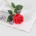 Single red velvet artificial rose on open magazine for elegant home wedding decor - Silk Red
