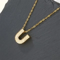 Gold-plated letter U necklace pendant with sparkling cubic zirconia on stone background - Letter U (Pendant Only)