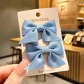 Pair of blue satin bow hair clips for girls on a handmade princess display card - 2-Piece Set / Blue