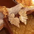 Vintage golden leaf-shaped earrings with intricate vein textures on a dark wooden box - Golden Leaf Vein Texture Stud Earrings