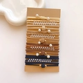 Close-up of assorted elastic hair ties with pearls and textures on a kraft card - Pearl Coffee Color Set
