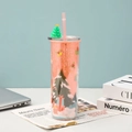 Detail shot of a pink Christmas straw cup with glitter and festive tree decorations - Style 1 (Pink/Christmas Tree)