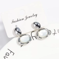 Fashionable silver-toned oval earrings with white mother-of-pearl inlay on jewelry card - White Gold