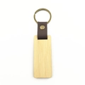 Close-up of rectangular wooden keychain with brown leather strap and bronze metal ring - Rectangular Bamboo
