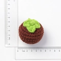Handmade crochet persimmon keychain with green leaf top shown with a measuring ruler - Dark Brown Knitted Mangosteen
