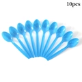 Detailed overhead view of 10 blue plastic spoons arranged for Oktoberfest parties - Blue Plastic Spoon