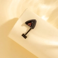 Black triangle screw-back cartilage earring with orange zircon on beige display - Black With Red Zirconia - Right Side (Single Piece)