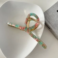 Detailed view of 13cm marble pink acetate hair claw with elegant golden metal spring - Green and Pink