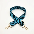 Detail of blue zebra pattern woven bag strap with adjustable gold-tone metal buckles - Aqua