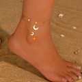 Close-up of 18k gold double-layer anklet with star and moon charms on the beach - 21+5cm / Star Moon Tassel Anklet (P110) / Gold