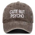 Detailed embroidery of 'CUTE BUT PSYCHO' on a vintage washed cotton baseball cap - One Size / Coffee