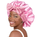 Pink satin sleep bonnet with a large decorative bow for night hair care protection - One Size / Deep Pink