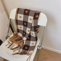 Brown and beige plaid scarf with heart patterns and fringes draped on a chair - Heart Plaid Coffee