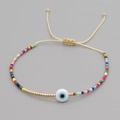 Detail of woven Miyuki bead bracelet with evil eye charm and adjustable sliding knot - Beige Rope Evil Eye Multi-color Beads (MI-B200498A)