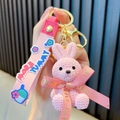 Niedlicher Häkel-Harz-Hasen-Schlüsselanhänger mit rosa Schleifenband, süße Tasche. - Rosa