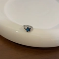 Elegant silver star earrings featuring vibrant blue zircon stones on a white ceramic tray - Single Hoop Earring / Blue Star