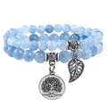 Blue beaded double-layer bracelet with tree of life and leaf pendants on white background - Aquamarine