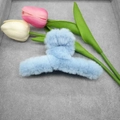 Detailed close-up of a large light blue plush shark hair claw clip with soft faux fur - Blue