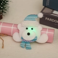 Detail of a glowing white bear Christmas brooch with a striped knit hat and LED lights - Glowing Bear with Arms