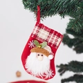 Close-up of red felt Christmas stocking with Santa Claus applique and plaid cuff detail - Small Bell Santa Stocking