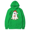 Green Christmas hoodie featuring festive ghost graphic with holiday lights and tree - Fruit Green