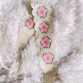 Handmade crochet headband with pink floral motifs on cream yarn over a soft faux fur background - Pink Flower