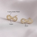 Golden infinity stud earrings crafted in copper with sparkling zircon on silk - Infinity Symbol Style