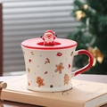 Close-up of white ceramic Christmas mug with 3D Santa lid and red handle details - Gingerbread Man (With Lid)