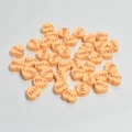 Close-up of 10mm apricot heart-shaped clay beads with red Love print for DIY jewelry - Orange