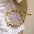 Bracciale a catena cubana dorata con croce in zircone su sfondo bianco testurizzato - Stile Croce in Pietra Taglio Fantasia