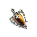 Detailed view of tiger eye gemstone pendant with silver star and rose vine metalwork - Tiger's Eye