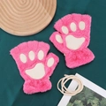Detail of pink cat paw plush fingerless gloves with cream neck strap on green fabric - One Size / Rose Red