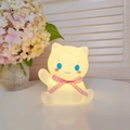 Cat-shaped night light with a pink bow and warm yellow glow on a clean white surface - Lucky Cat - Pink
