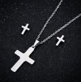 Detailed view of silver cross jewelry set including a necklace and stud earrings - Cross / Steel