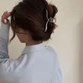 Elegant polished silver metal hair claw clip with heart cutout worn by a model - Heart Hollow Wave Style / Large / Silver