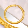 Close-up of 18K gold-plated chunky snake chain necklace with K18 tag on white satin - Gold