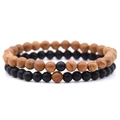 Close-up of distance bracelets with 8mm brown wood and matte black stone beads - Wood Grain