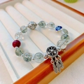 Ethnic beaded bracelet with green phantom crystal and red agate on jewelry display tray - Green Ghost: Dreamcatcher Bracelet