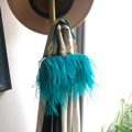 Turquoise ostrich feather clutch bag with gold ring closure and leather strap handle - Lake Blue